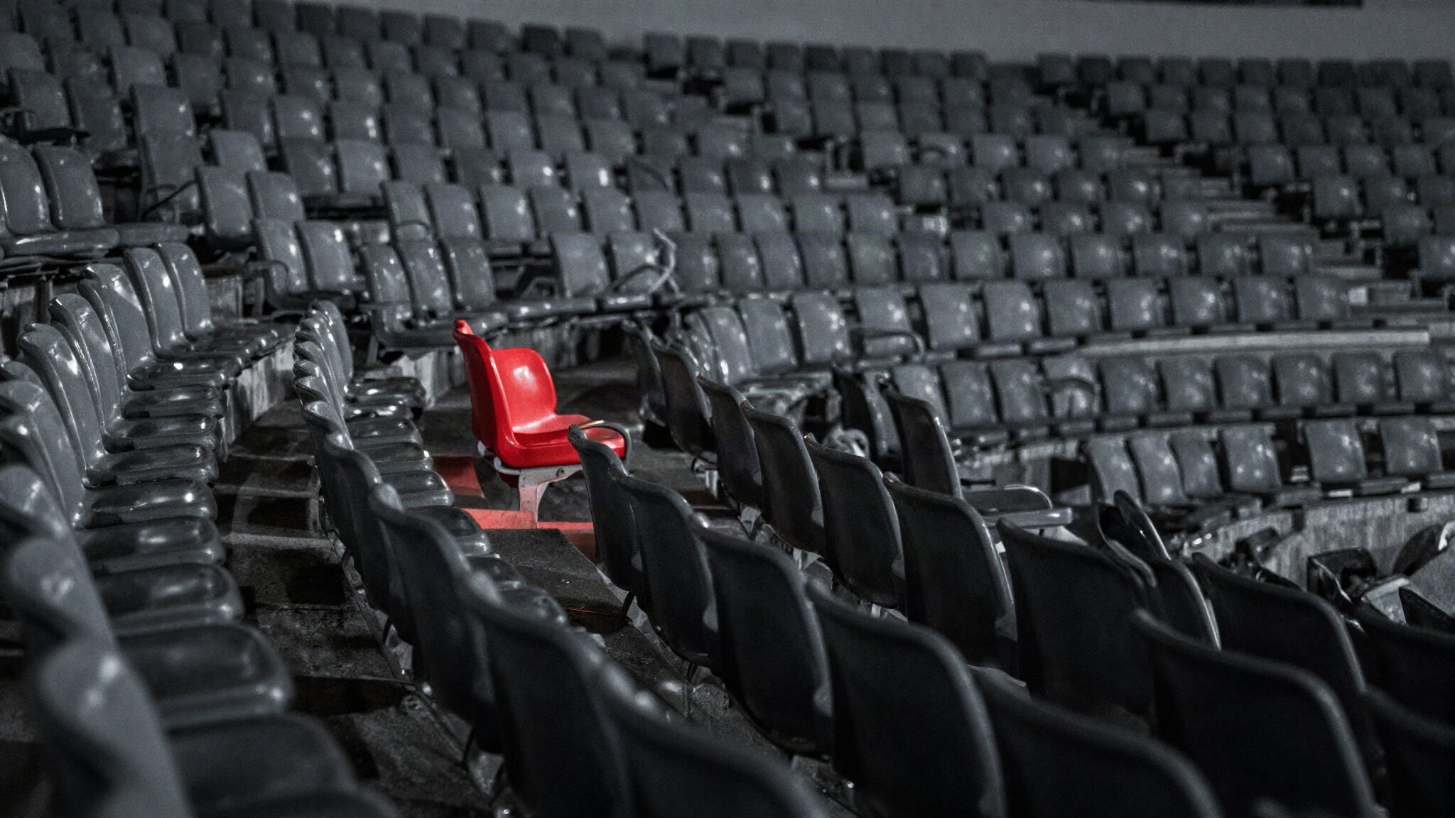 Audience relevance in advertising: rows of empty grey stadium seats with one red seat